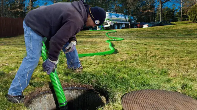 Service technician performing residential septic pumping and drainage maintenance in Henderson, NV